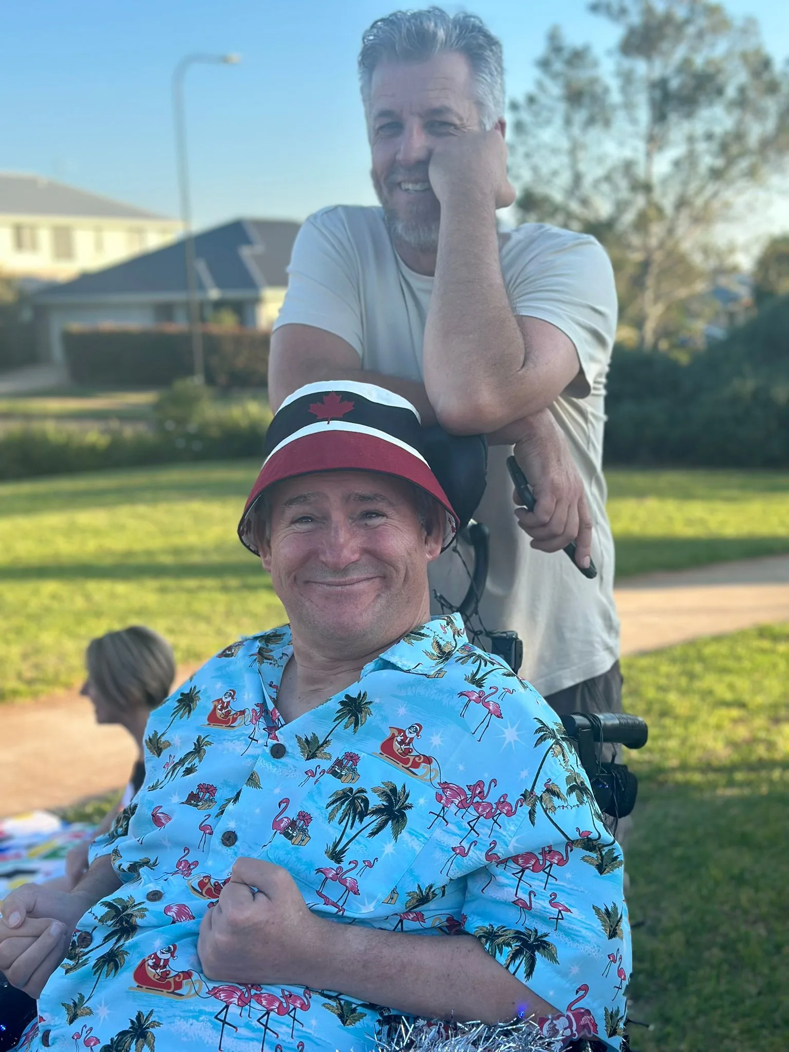 A participant and support worker at the park at golden hour