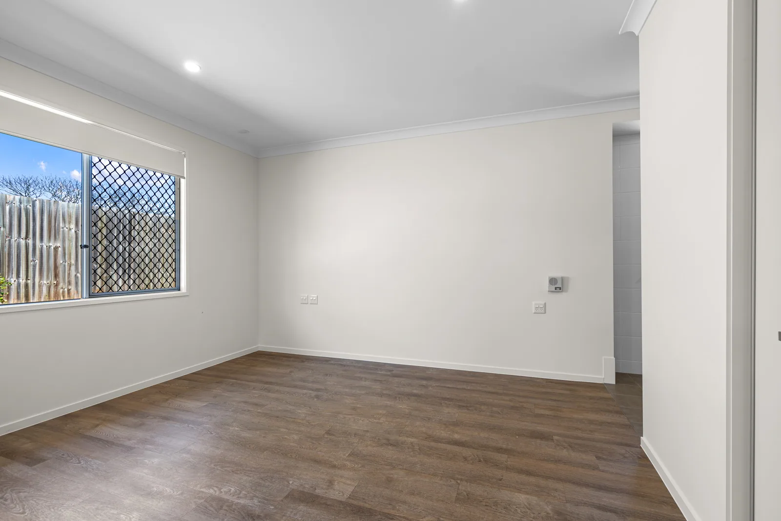 A bright bedroom with a window onto the garden