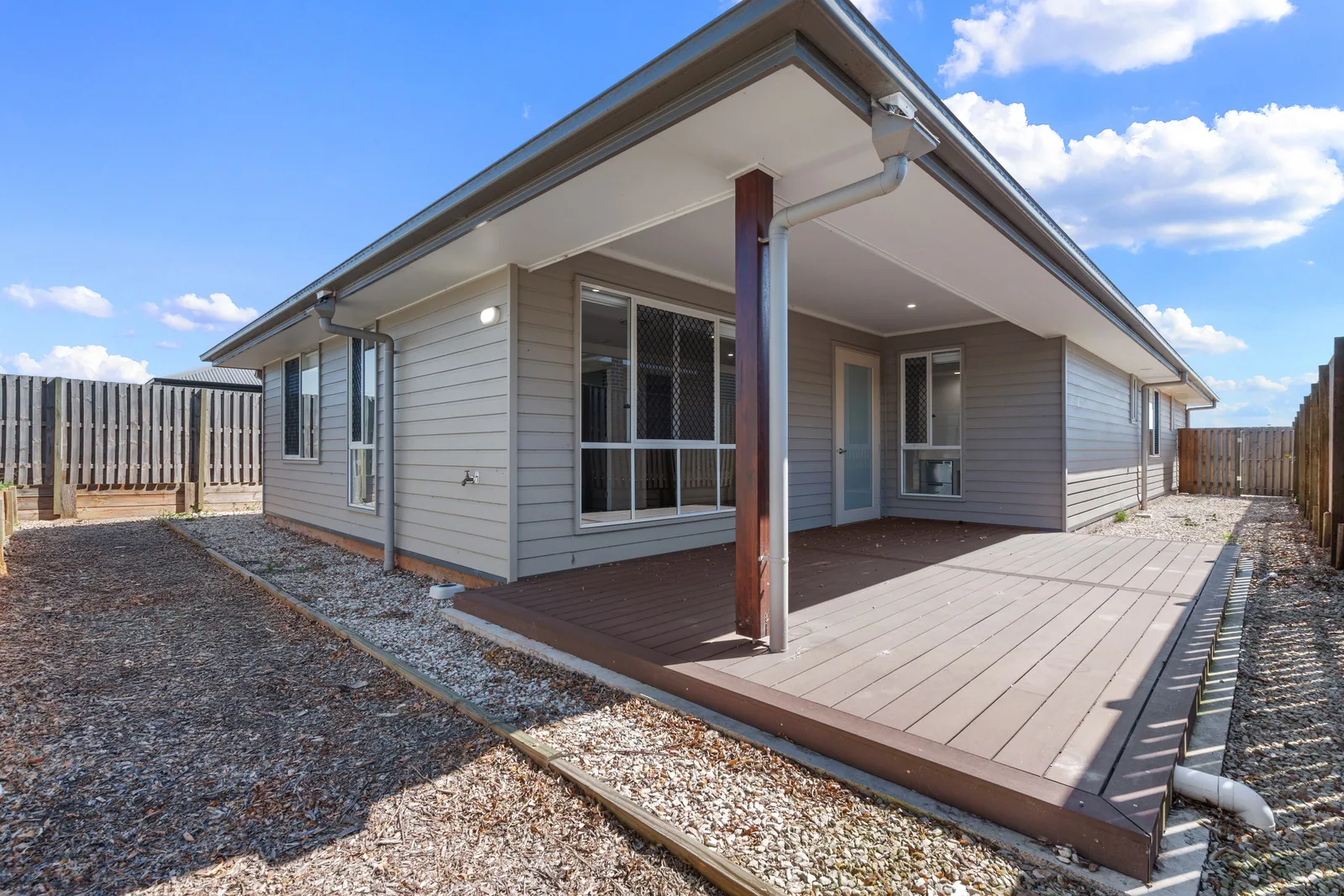 Rear of a high physical support house, with a covered timber deck