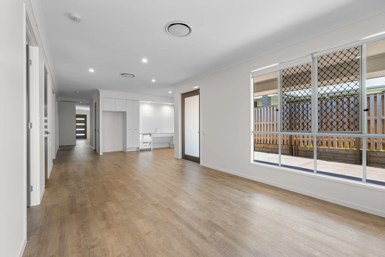Wide hallway with level flooring leading to the living area