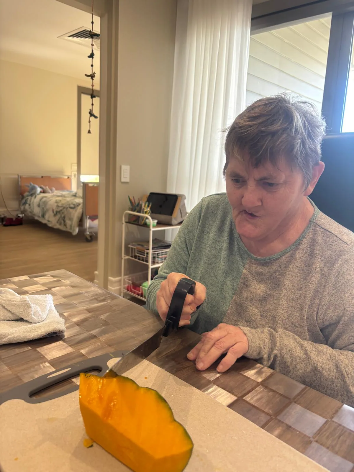 A participant preparing vegetables at the table