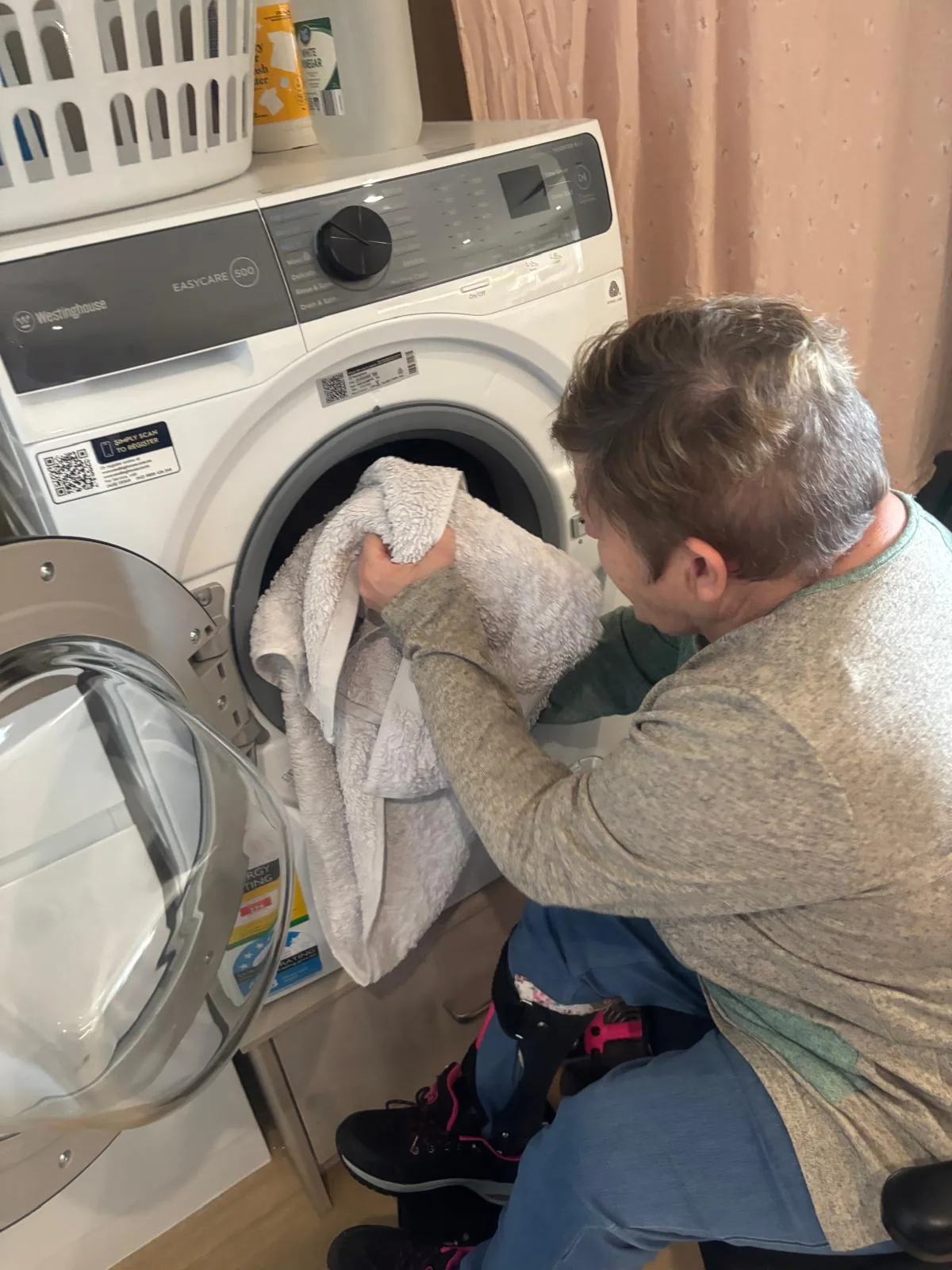 A participant loading the washing machine
