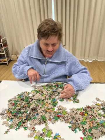 Raelee working on a large jigsaw puzzle
