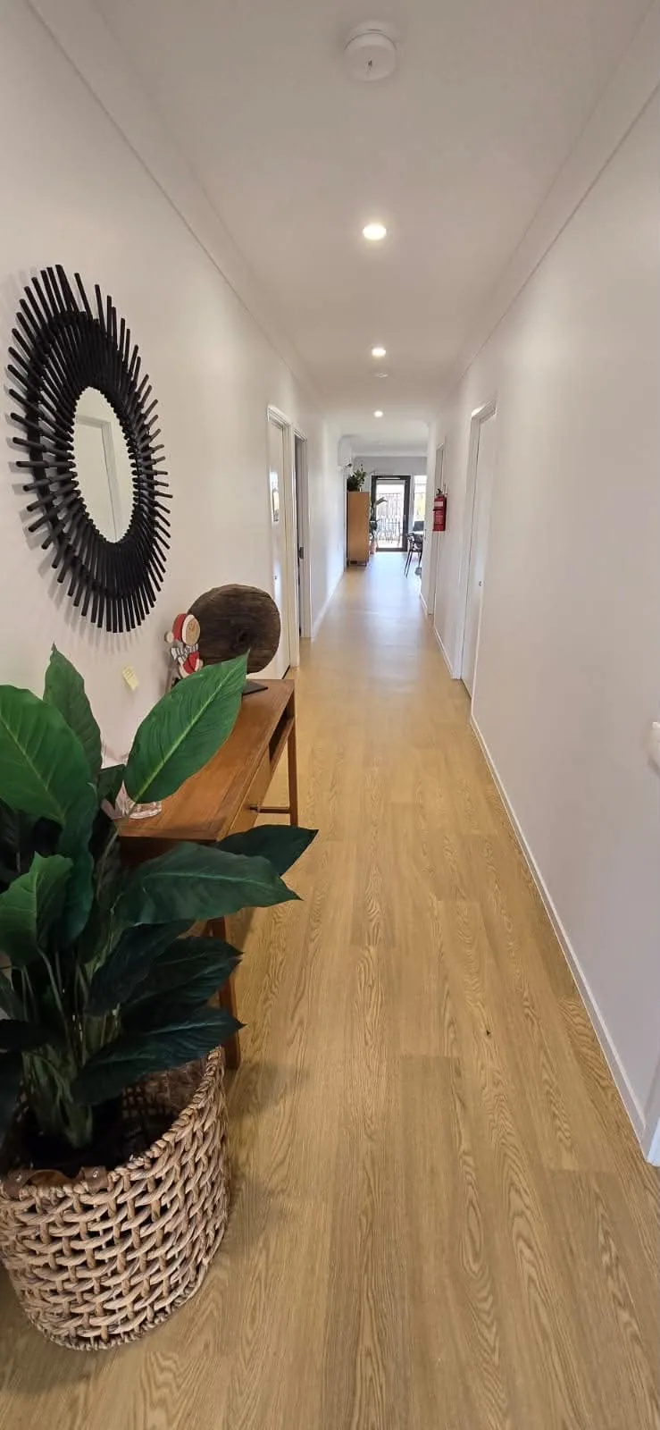 Wide hallway with level flooring throughout the home