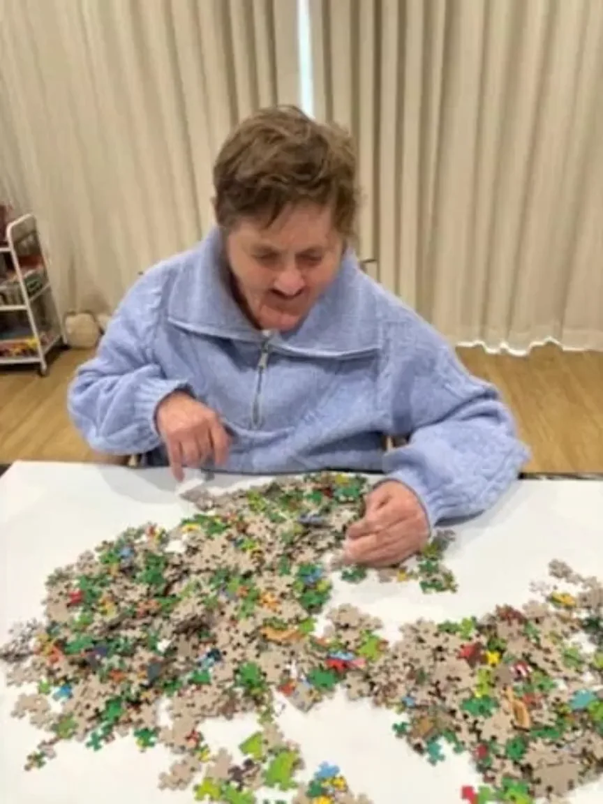 Raelee working on a thousand-piece jigsaw at home
